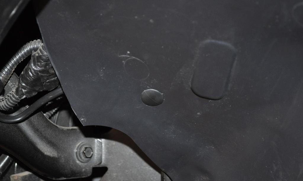 Toward the front of the inner fender liner, there is a small hole in the OEM tub frame brace, behind the inner fender liner, as shown in figure 37.