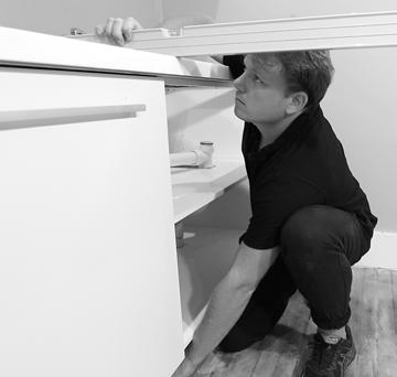 INSTALL THE CORNER CABINET FIRST If your kitchen has a corner, start there. Position the cabinet and adjust the legs until the cabinet matches up with the line you marked out in Step One.
