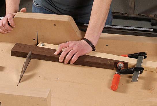 After tapering the legs, use a skewed fence on a crosscut sled to cut