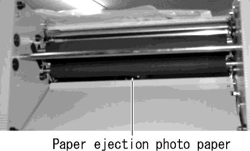 If only one sheet of paper is being fed, use a soft cotton swab to remove paper dust, etc. from the face of the paper ejection photo sensor shown by the arrow.