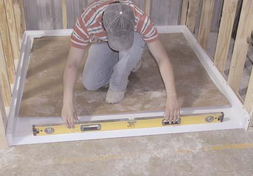 If shimming over 1/8 is required, remove the pan and correct the sub-floor area by floating a floor leveling compound. Figure 9A 11. Drill holes through the mounting flanges into each framing stud.