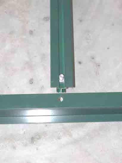 With the base rail in position, insert the bolt of one door supports through the predrilled hole in the base rail and hold the bolt