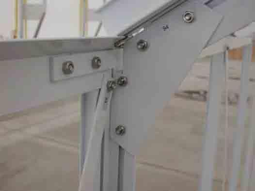 5. Using four bolts in the double track vertical support (sidewall), install the lower support bracket to the vertical as shown in the following photo.