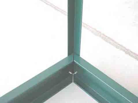 The dashed line shows the lip of the base rail of the greenhouse. NOTE: Place screws evenly around the perimeter of the frame between each vertical support. 7.