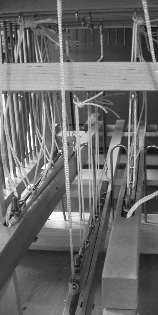FIRST SHED When you depress the Treadle, the Rocker Loop Cord raises the front of the Rocker setting the Shafts at the correct Level.
