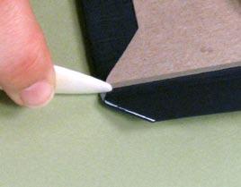 To make the mitred corners, use the bone folder to tuck in the little