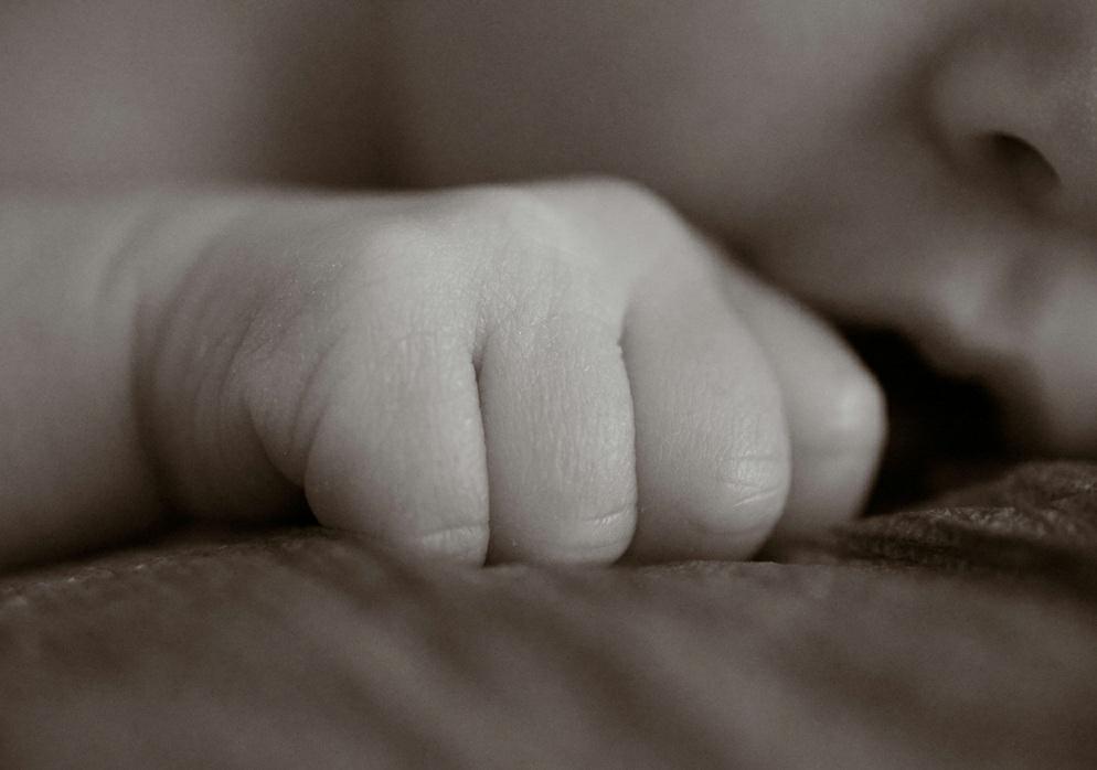 A portrait can include in focus details such as the baby s hand, while the baby s face is softly out of focus in the background.