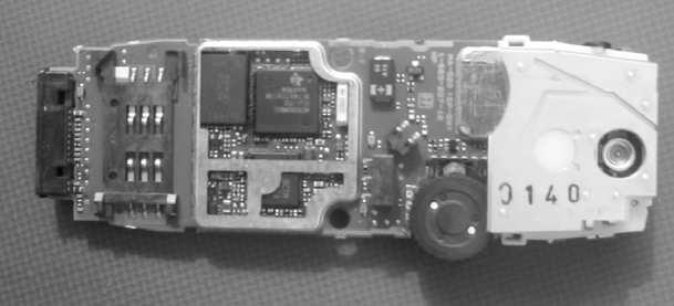 Figure 1.1: Photograph illustrating the internal parts of a hand phone The integrated circuits appearing in this example have various sizes and complexities.