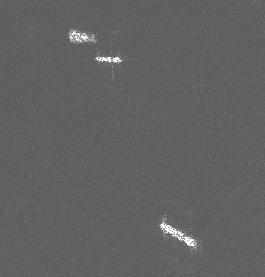 Figure ##F4. Details of RADARSAT images showing ships. The rightmost target resembling a streak is a fast moving ferry and its shape is distorted.