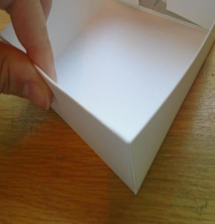 tabs at either end. Step 26. Fold the tab over the box side so it covers the corner tabs.