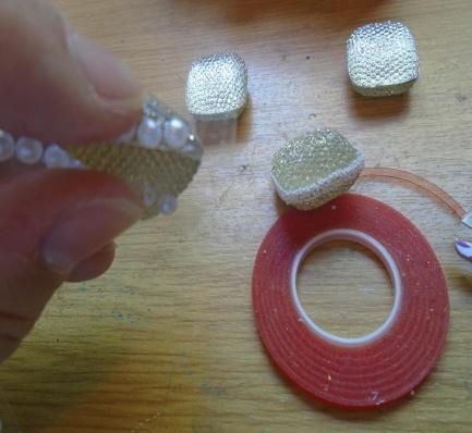 Step 55. or use the self adhesive pearls. Remove the red line carrier backing from the tape and then add some of the snow white micro beads on to tape.