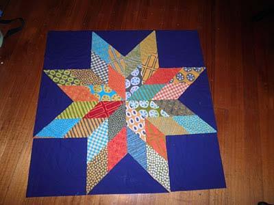 of the quilt. Sew the triangle in the centre in the same way, making the point at the apex of the triangle.