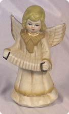 Concertina-playing angel stands in front