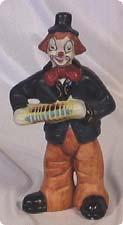 Colorful ceramic clown plays concertina. Ca.
