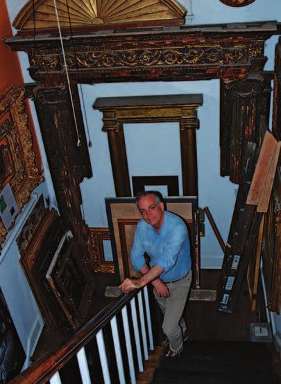 Adair pauses in the back stairway in front of a Tuscan tabernacle frame that once belonged to American architect Stanford White.
