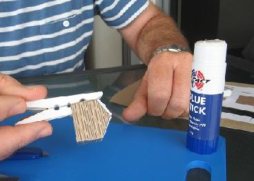 Use a glue stick or super glue to adhere the