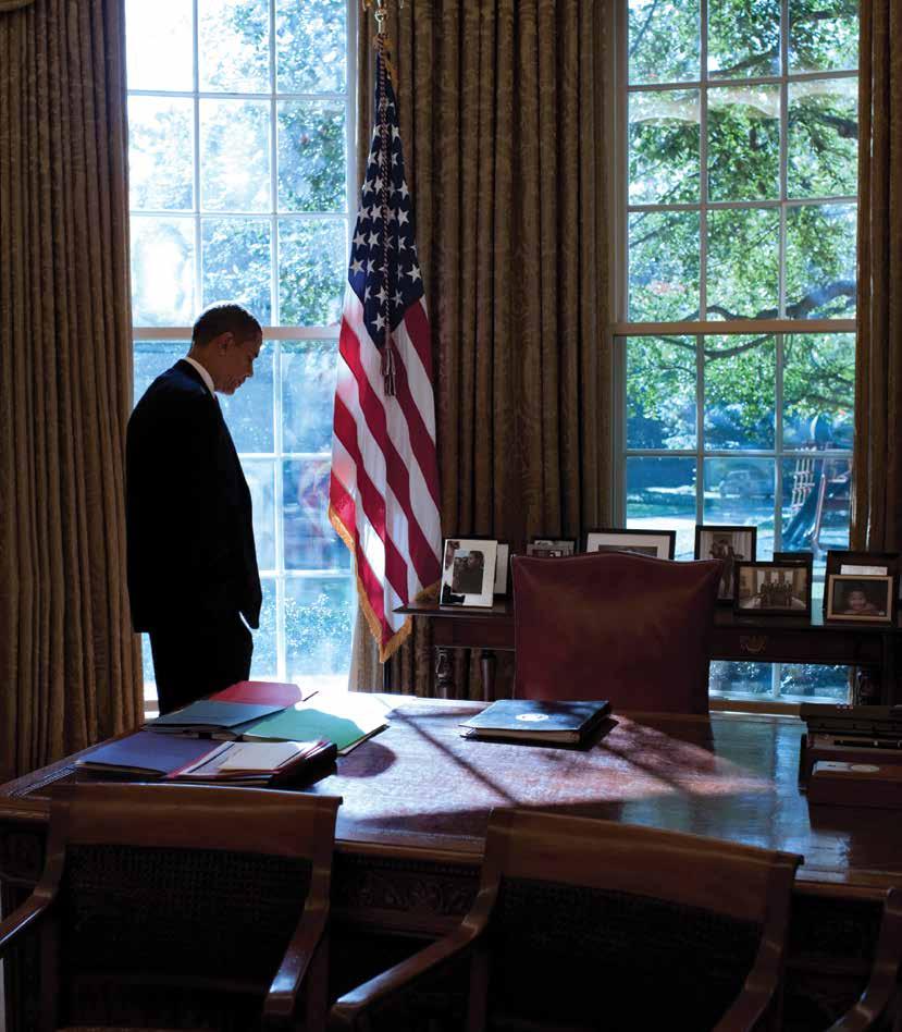 President Barack Obama 83 walks to his desk in between