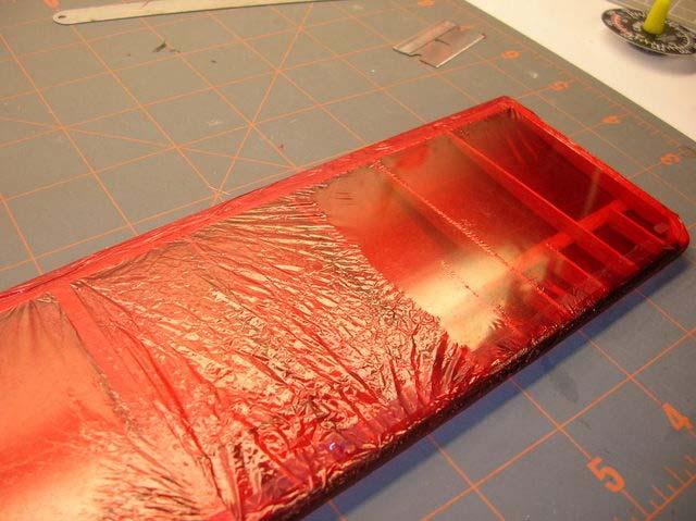 Trim the excess with a brand new razor blade. I trim the mylar flush on the top side. Repeat the same process on the bottom.