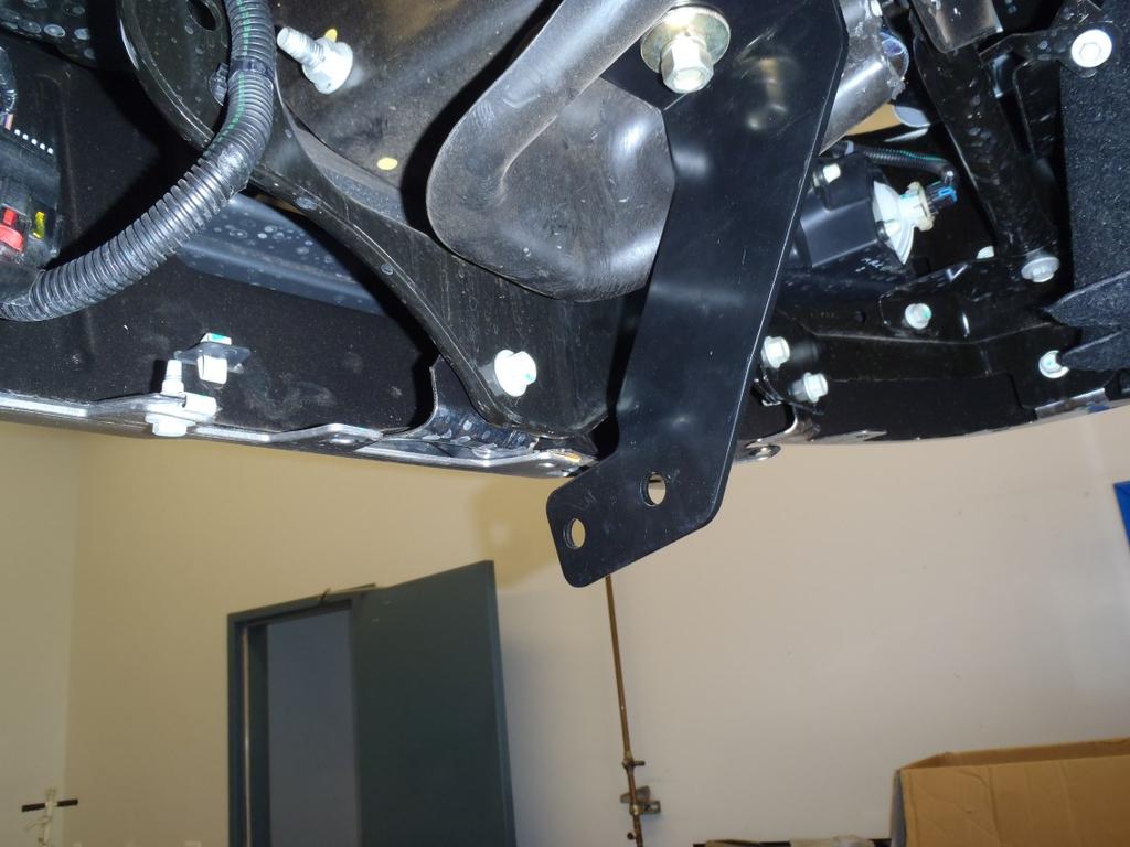 Re-use the factory M10 hardware and supplied M6 hardware to loosely install the Lower Mounting Brackets (Figure 10). Lower Support Bracket installed on stud with M12 hardware (Passenger Side shown).