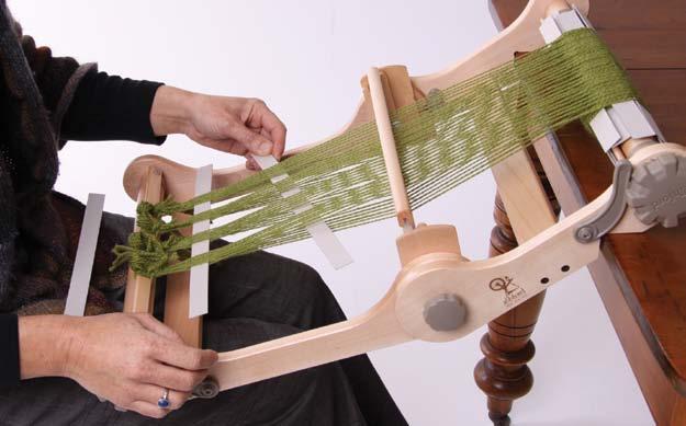 Slide it to the front of the loom. Change the reed to down weaving position.