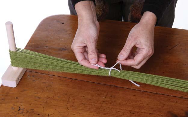 Take a 15cm (6ins) length of yarn.