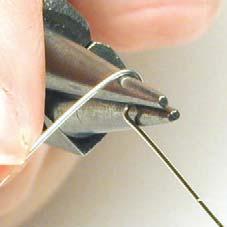 a) Holding the needlenose chain pliers grab the wire about one inch from the end.