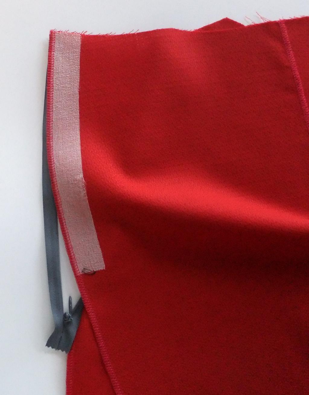 Place the corresponding garment piece over the remaining zipper tape with right sides together.