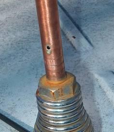 A brass plug with a 3/8" x 24 threaded hole was pressed into the end of the copper pipe and hard-soldered into place.