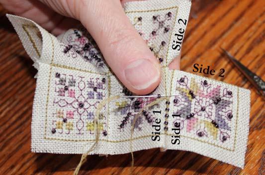 Slip under a matched pair of backstitches.