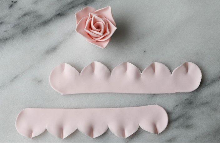 Brush a line of gum paste glue horizontally through the center of the petals.