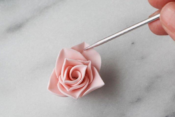 Set the coil on its bottom, then use a knitting needle or tooth pick to open the petals up.