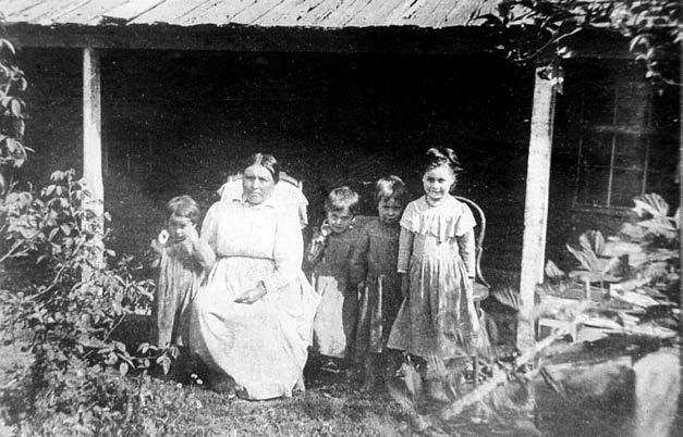 MARY STOOQUIN, who was a little girl, fled in terror when federal troops rounded up Cascade Indians following the Fort Rains Massacre, is seen with grandchildren in photo taken about 1902.