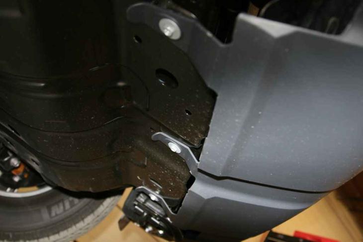 2. Using a Phillips Head screwdriver, remove the three screws from the bottom plastic on the bumper. See image below. Figure 2 LOWER BUMPER PLASTIC REMOVAL 3.