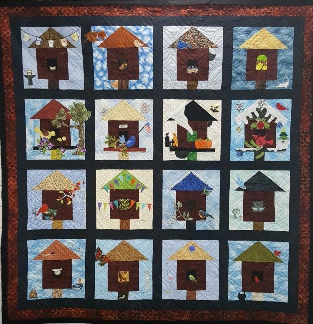 This 60" x 62" wall hanging is a work of art pieced by many community quilters.