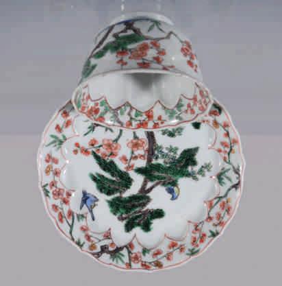 25. A Chinese famille verte tea bowl and saucer, the tea bowl painted eith the Three Friends of Winter, with bamboo and