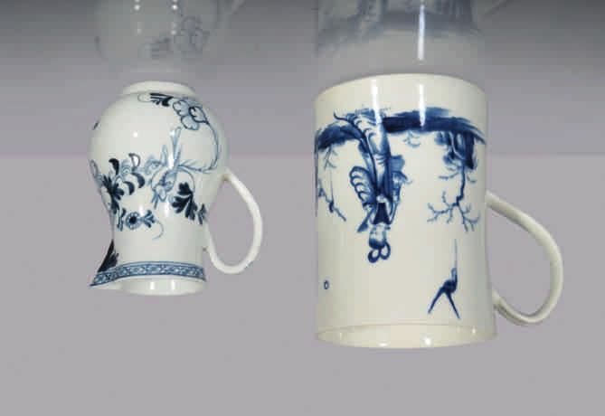 A Liverpool baluster shaped sparrow beak milk jug, with notched loop handle, painted in underglaze blue with a bird on a branch, in Chinese style, beneath a diaper