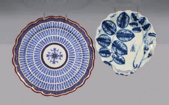 A rare Flight Worcester plate, painted in underglaze blue with the Music pattern, within a blue and gilt flower panelled trellis border, and brown line rim, 7 ½" diameter, circa 1785, blue crescent