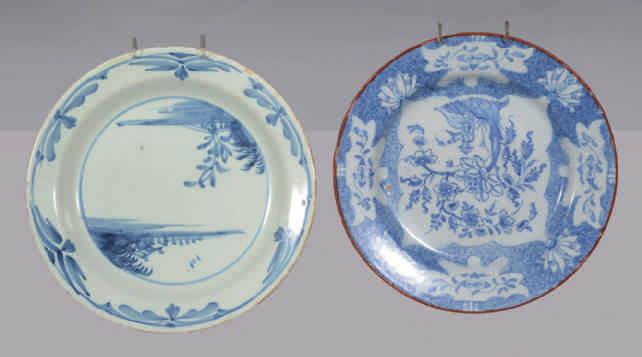 55. A Lambeth Delft plate, simply painted in blue in Chinese style with a river landscape, within a roundel, the rim with stylised flower heads, 8 ¾" diameter, circa 1720, no mark 56.