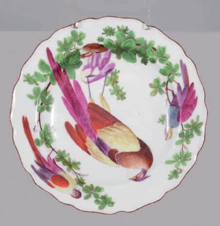77. A Chelsea plate, finely painted in coloured enamels with a cut melon, nuts and berries, in Hans Sloane style, the indented border with brown line rim, 8