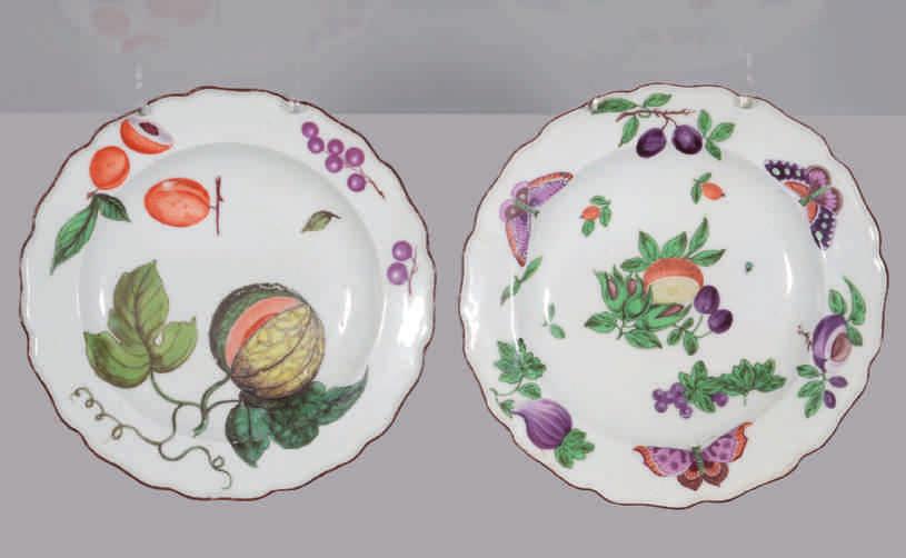 A Chelsea plate, boldly painted in coloured enamels with a cluster of nuts, plums and a cut orange, and with scattered fruits, the border with three