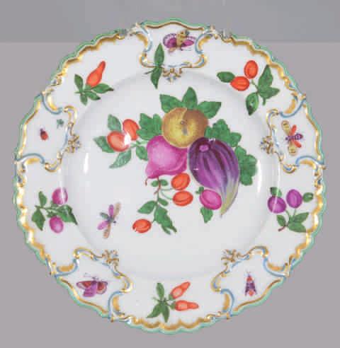80. A fine Chelsea plate, from the Duke of Cambridge Service, boldly painted in coloured enamels with a cluster of fruits and leaves, and a winged insect, the border with fruits and