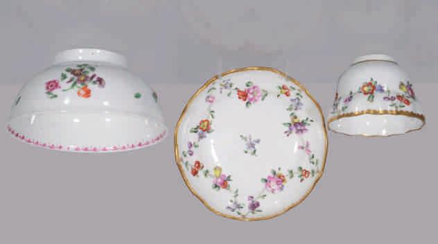 A Bristol small round bowl, the exterior painted in coloured enamels with a spray of flowers and leaves, and scattered flowers, the interior with a central pink rose, within a puce pendant flower