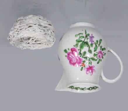 111. A Bristol baluster shaped sparrow beak milk jug, with loop handle, boldly painted in Chinese famille rose palette with three sprays of flowers and leaves, the interior of the rim with a green