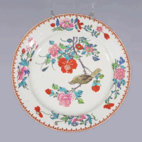 125. A rare Worcester plate, pencilled with a bird on a flowering branch, in Chinese famille rose style, the border with four sprays of flowers, within a gilt spearhead band, 8 ¾" diameter, circa