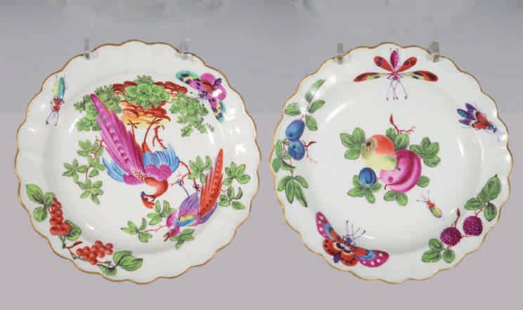 127. A fine Worcester plate, brilliantly painted in coloured enamels in the London atelier of James Giles with an exotic bird perched on rockwork, and another in a tree, the fluted border painted