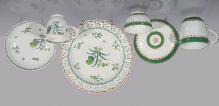 135. A Worcester coffee cup and saucer, the cup with notched loop handle, painted in shades of green with poppies and leaves, picked out in gilt, within green interlinked borders, circa 1775, no mark