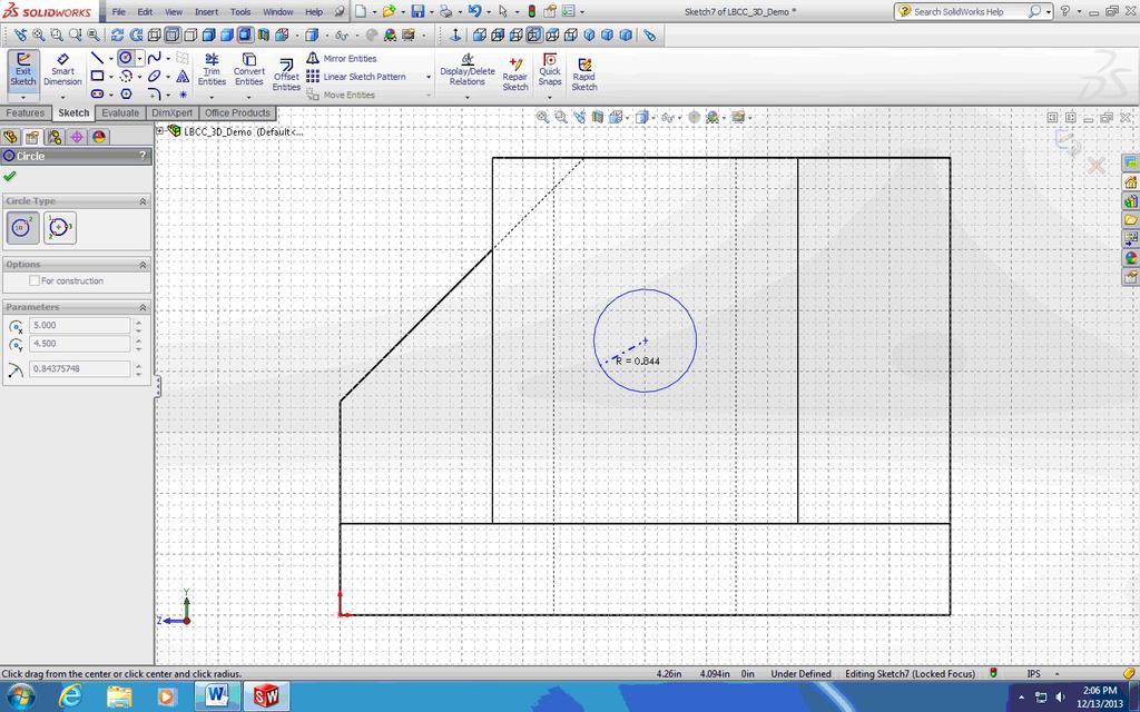 Circle tool, move the mouse over the center point of the top edge of the cylindrical boss to pick up the snap, then move the mouse downward vertically; then move the mouse over the left vertical edge