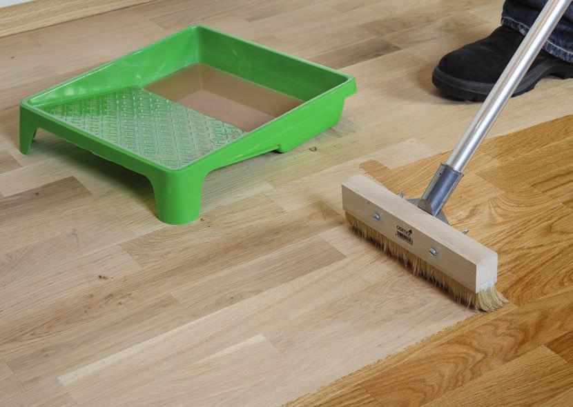 Choose a corner of the room to begin applying finish. Make sure you can back out of the room without having to cross wet finish. Dip the floor brush into the finish about 1/4 deep.