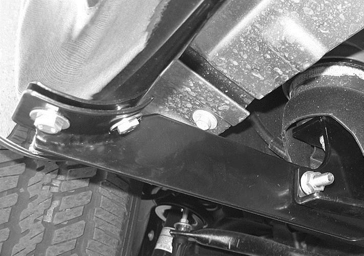 8. Carefully position the driver step bar onto the mount brackets.