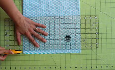 There will be four layers of fabric. Hand press wrinkles out. Step 3. Line a ruler up across the fabric.